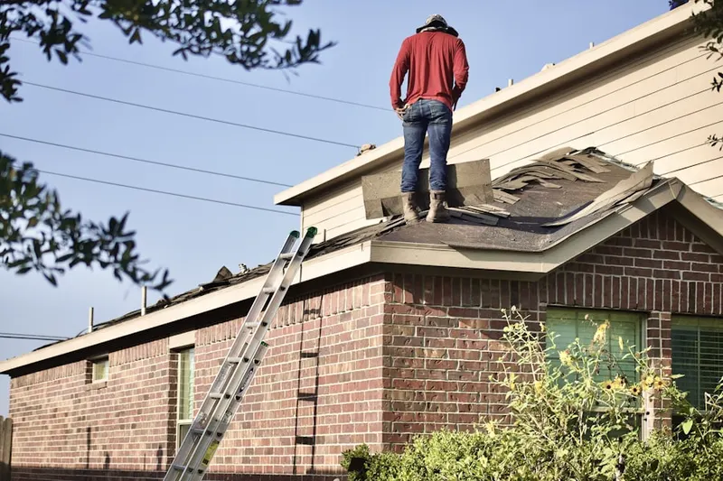 Professional roofer working on a residential roof in Barbecue